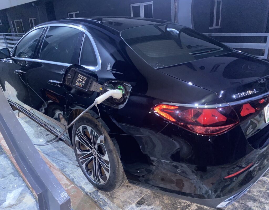 Electric saloon connected to a home EV charger in Abuja