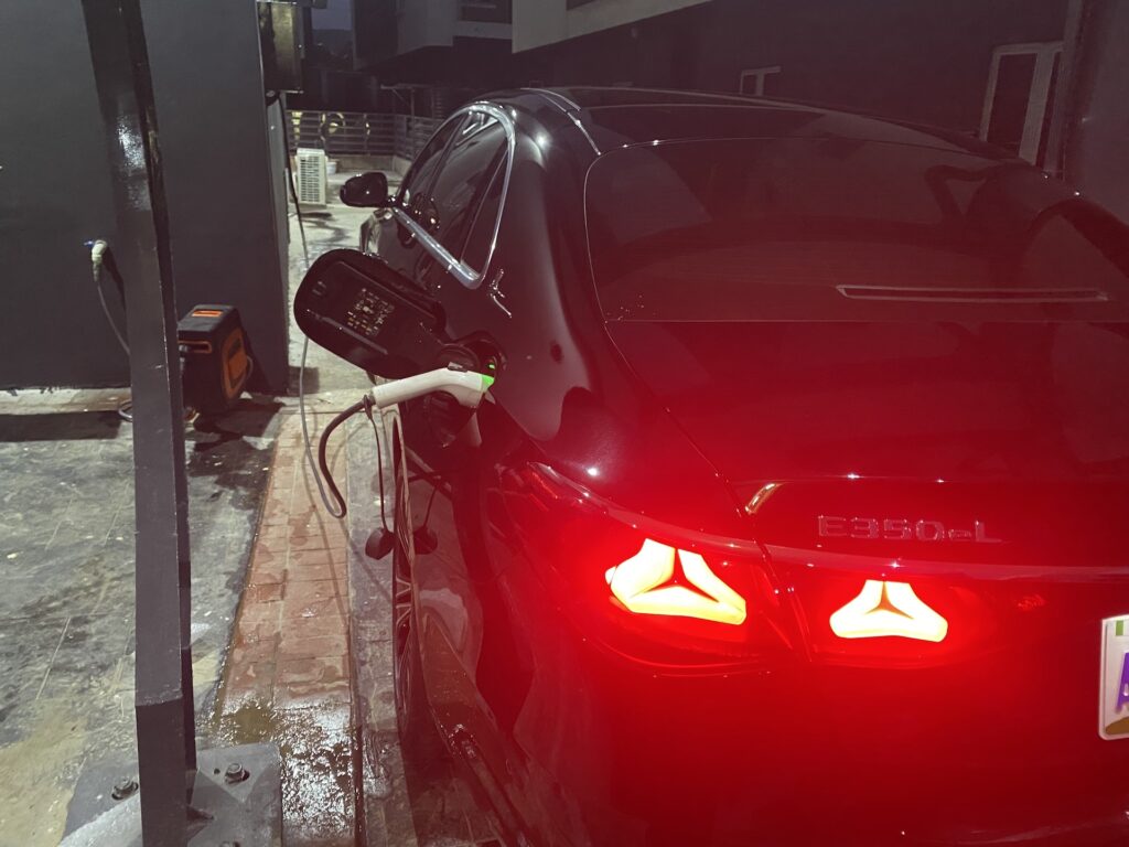 Electric car charging at night from an EV charger in Abuja
