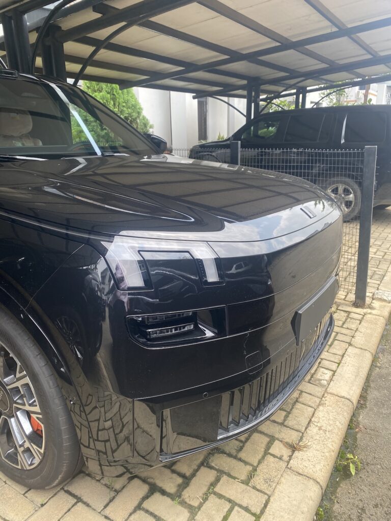 Electric SUV charging under a car port in Abuja