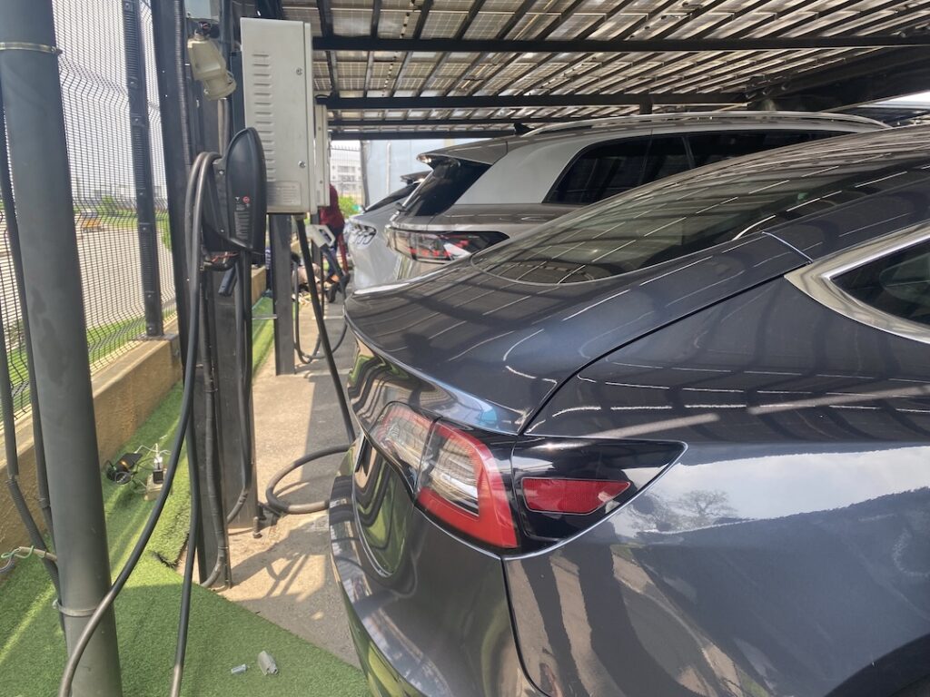 Charging cable connected to an electric car at an Abuja property