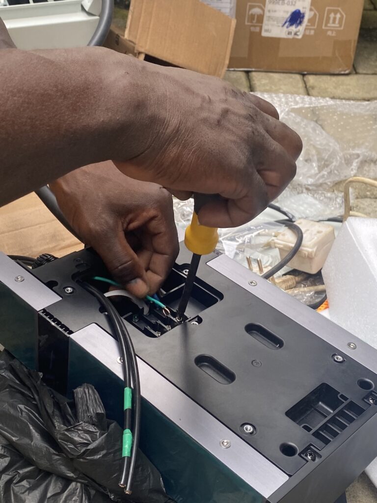 Electrician terminating EV charger wiring during an installation in Abuja