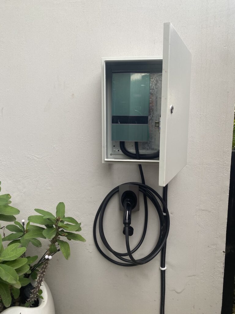 EV wall charger with cable holster installed at an Abuja residence