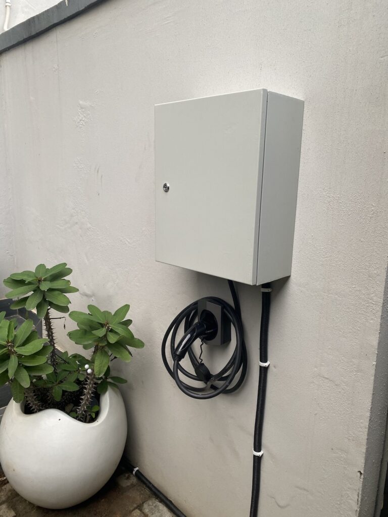 Home EV charger unit fixed to an exterior wall in Abuja